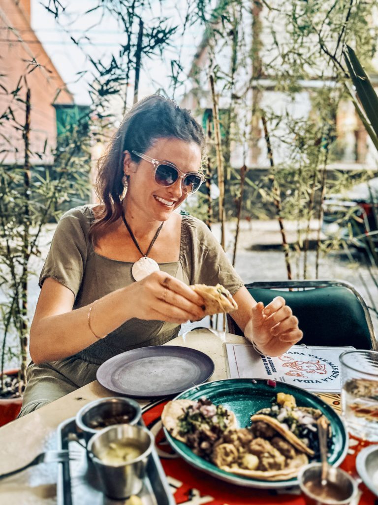 food travel blogger enjoying tacos in mexico